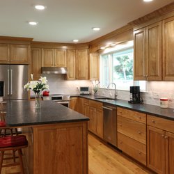 Michaud Enterprises - Custom kitchen designed by Michaud Enterprises, features granite sitting island and hardwood cabinets.