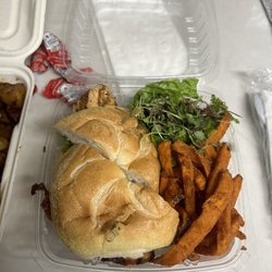 Grilled chicken sandwich with sweet potato fries and a salad