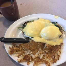 Eggs Rosario - Eggs Benedict over spinach on an English muffin with a side of crispy hash brown. Eggs Rosario - Eggs Benedict over spinach on an English muffin with a side of crispy hash brown.
