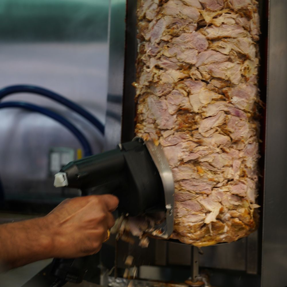 Pita Lite - a man putting meat on a skewer - Mediterranean Near Me - Toronto, Ontario Pita Lite - a man putting meat on a skewer - Mediterranean Near Me - Toronto, Ontario