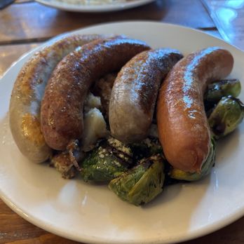 Schwätzer's German Restaurant - A mix of 4 German style sausages with warm potato salad and Brussel sprouts. - German Near Me - Seymour, Indiana Schwätzer's German Restaurant - A mix of 4 German style sausages with warm potato salad and Brussel sprouts. - German Near Me - Seymour, Indiana