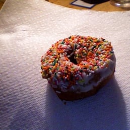 a donut with sprinkles on a napkin a donut with sprinkles on a napkin