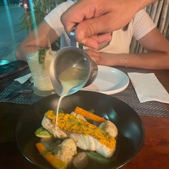 Fuego De Mar - Chile and peanut encrusted snapper with vegetables and corn consume - Seafood Near Me - Isla Mujeres, ROO Fuego De Mar - Chile and peanut encrusted snapper with vegetables and corn consume - Seafood Near Me - Isla Mujeres, ROO