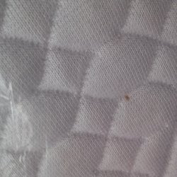 "brand new mattress" in plastic with stains and wear marks before opening!