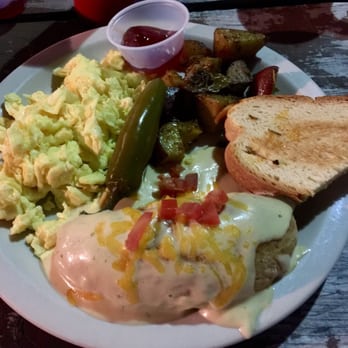 Cafe Brazil - Brazilian breakfast- 2 eggs, Chorizo Empanada topped with Spicy Cream Sauce, Cheese, and Tomatoes with rosemary potatoes and toast - Breakfast & Brunch Near Me - Dallas, Texas