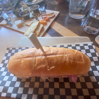 Brickroom - Polish rope sandwich, with cheese plate in the background. - New American Near Me - Ashland, Oregon Brickroom - Polish rope sandwich, with cheese plate in the background. - New American Near Me - Ashland, Oregon