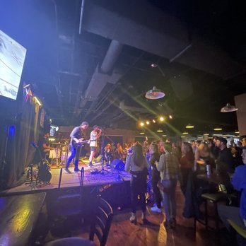 Arlington Ale House - a man standing on a stage in front of a crowd - Venues & Event Spaces Near Me - Arlington Heights, Illinois Arlington Ale House - a man standing on a stage in front of a crowd - Venues & Event Spaces Near Me - Arlington Heights, Illinois