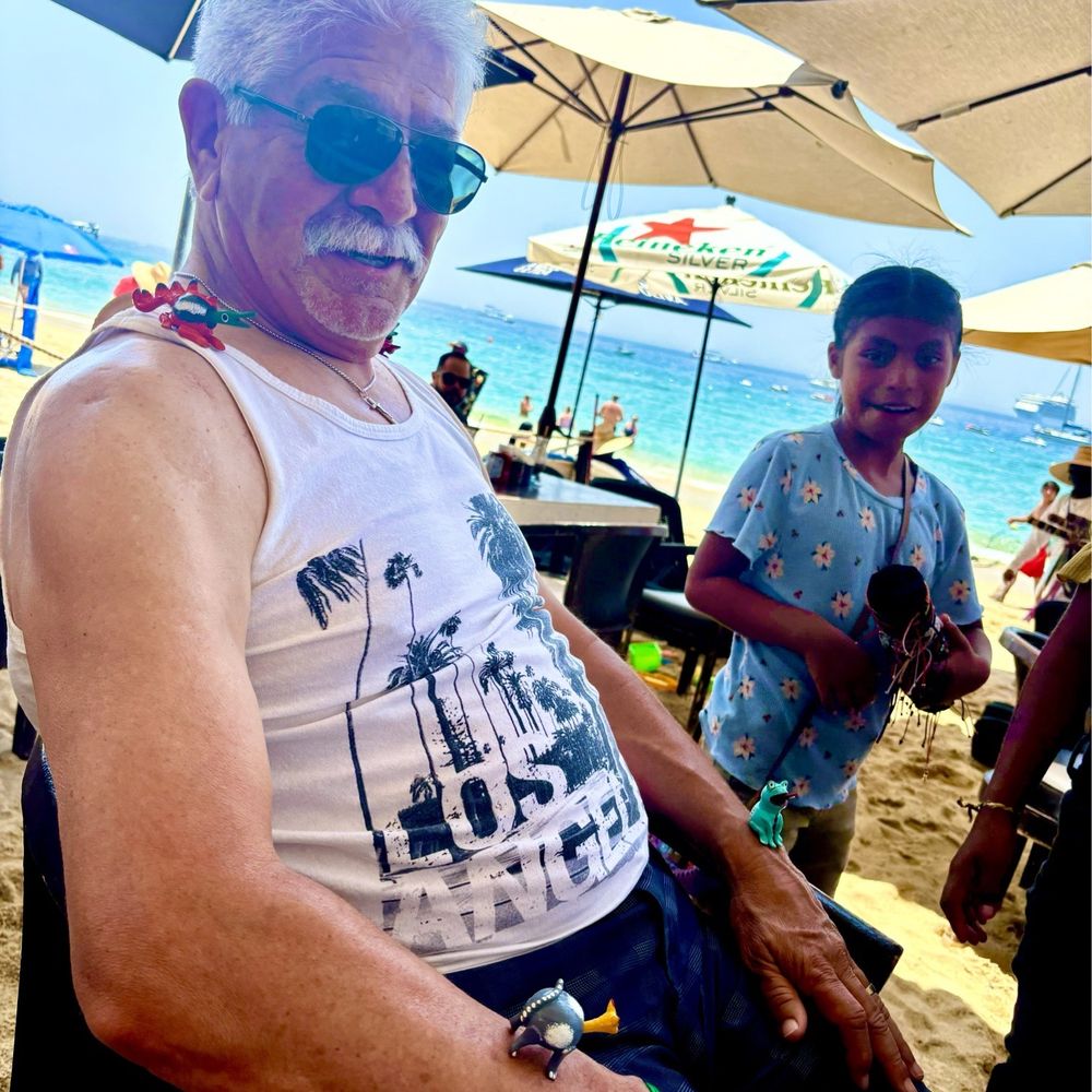Omega - Some young girls trying to sell toys to a 70 year old man. Good luck. - Mexican Near Me - Cabo San Lucas, BCS