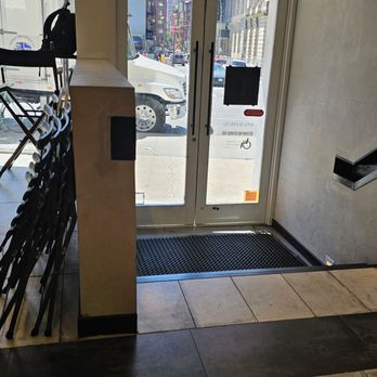 The Lost Draft - The entry way has stairs but zoom in on the front door ,there the sign for next door accessibility - Coffee & Tea Near Me - New York, New York