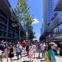 a crowd of people walking down a street a crowd of people walking down a street