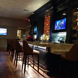 a bar with chairs and televisions a bar with chairs and televisions