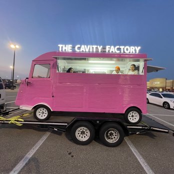 The Cavity Factory - a pink food truck in a parking lot - Food Trucks Near Me The Cavity Factory - a pink food truck in a parking lot - Food Trucks Near Me