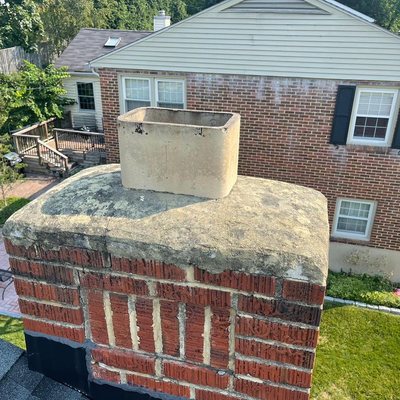 New crown seal and cap - This customer had cracks in their crown seal; when these cracks begin to surface on the crown, it exposes the interior of the chimney to moisture. Without repairs, the crown will continue to deteriorate. We gave the crown a new coating of crown seal to keep the cracks from growing and letting in moisture.
The chimney cap was also missing; it serves several purposes, including keeping rain out of your chimney. The mesh wire around the cap will help keep out birds and any other unwanted visitors. We replaced the chimney cap with a nice stainless steel cap that will help keep out water and animals. New crown seal and cap - This customer had cracks in their crown seal; when these cracks begin to surface on the crown, it exposes the interior of the chimney to moisture. Without repairs, the crown will continue to deteriorate. We gave the crown a new coating of crown seal to keep the cracks from growing and letting in moisture.
The chimney cap was also missing; it serves several purposes, including keeping rain out of your chimney. The mesh wire around the cap will help keep out birds and any other unwanted visitors. We replaced the chimney cap with a nice stainless steel cap that will help keep out water and animals.