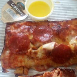 Pepperoni slice with garlic sauce on the side Pepperoni slice with garlic sauce on the side