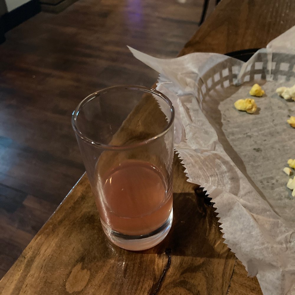 a glass of wine and a tray of popcorn a glass of wine and a tray of popcorn