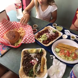 Flautas, carne asada and pastor tacos. And a hamburger. The flautas are Flautas, carne asada and pastor tacos. And a hamburger. The flautas are