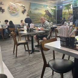 Vietnamese diners inside the noodle house. Vietnamese diners inside the noodle house.