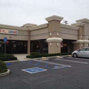 JnJ Flooring - a woman standing in front of a building - Flooring Near Me - Artesia, California