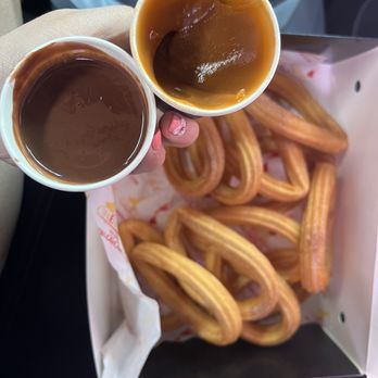 Ole Churros - Their popular Spanish Hot Chocolate (left) and the Dulce de Leche (right) dipping sauces. - Spanish Near Me - Paradise, Nevada Ole Churros - Their popular Spanish Hot Chocolate (left) and the Dulce de Leche (right) dipping sauces. - Spanish Near Me - Paradise, Nevada