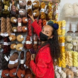 Sweet Pea Fiber - Owner Sarah taking special care to arrange the yarn