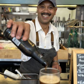 Tarragon Cafe - Owner Mario pours a cold one - Cafes Near Me - San Francisco, California