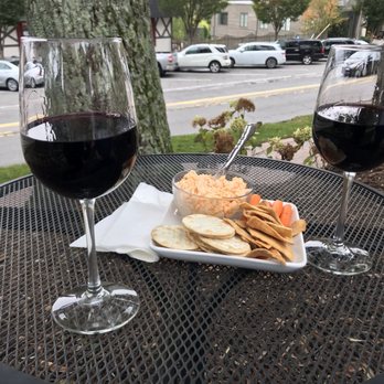 Highlands Wine Shoppe - two glasses of wine and a plate of cheese and crackers - Wine Bars Near Me - Highlands, North Carolina
