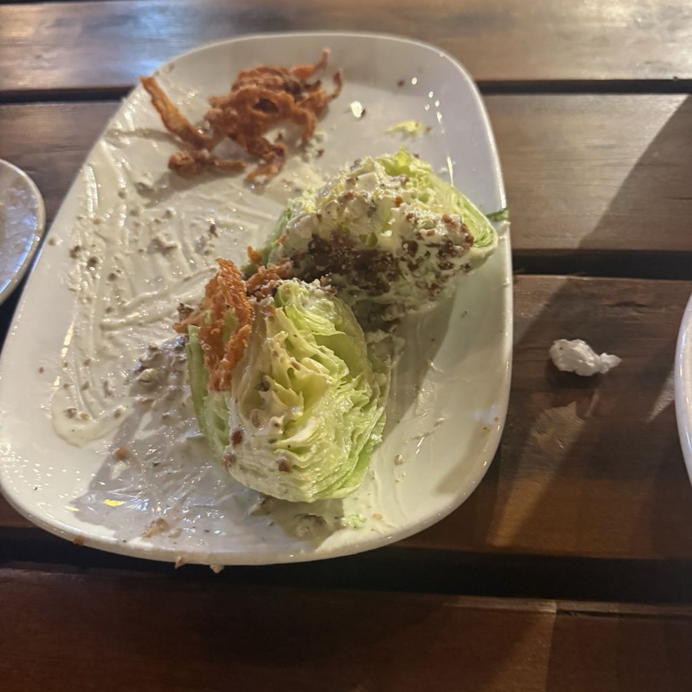 Abendigo's Grill & Patio - The wedge salad. I promise the picture doesn't do it justice. This is half eaten because I forgot to take a picture before I had to try it - Bars Near Me - Broken Bow, Oklahoma Abendigo's Grill & Patio - The wedge salad. I promise the picture doesn't do it justice. This is half eaten because I forgot to take a picture before I had to try it - Bars Near Me - Broken Bow, Oklahoma