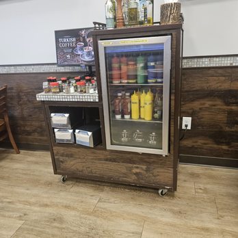 Mediterranean Turkish Cuisine - Variety of olive oils, sauces and condiments in spotless containers instead of on a counter or squeeze packets. - Turkish Near Me - Framingham, Massachusetts