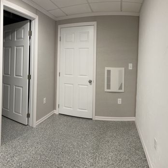 Owens Corning Basement Finishing System - a room with a door and a mirror - General Contractors Near Me - Canton, Massachusetts Owens Corning Basement Finishing System - a room with a door and a mirror - General Contractors Near Me - Canton, Massachusetts