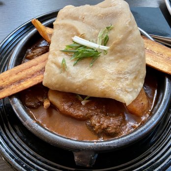 Oyo - Curry Goat with Dhalpuri Roti - Latin American Near Me - Pleasanton, California Oyo - Curry Goat with Dhalpuri Roti - Latin American Near Me - Pleasanton, California