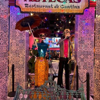 Aztecas Restaurant & Cantina - DÃa de los muertos metal statues in the left center complimenting the decor and theme of the restaurant - Tex-Mex Near Me - Mobile, Alabama Aztecas Restaurant & Cantina - DÃa de los muertos metal statues in the left center complimenting the decor and theme of the restaurant - Tex-Mex Near Me - Mobile, Alabama