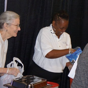 Lucille's Catering - Chef Mertis and volunteer working the Bridal Extravaganza - Caterers Near Me Lucille's Catering - Chef Mertis and volunteer working the Bridal Extravaganza - Caterers Near Me