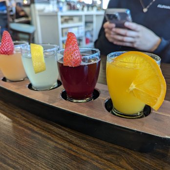 Broken Yolk Cafe - Mimosa Flight, left to right: grapefruit, lemonade, pomegranate, OG OJ. - Breakfast & Brunch Near Me - Fullerton, California Broken Yolk Cafe - Mimosa Flight, left to right: grapefruit, lemonade, pomegranate, OG OJ. - Breakfast & Brunch Near Me - Fullerton, California