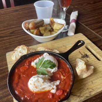 Idle Hour Winery & Kitchen - Brunch! Tomato Shakshuka, potatoes and sage sausage with a pomegranate mimosa - Wineries Near Me - Oakhurst, California