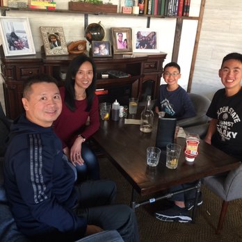 The Hideout Kitchen - Cozy table by the fire in the library. - New American Near Me - Lafayette, California