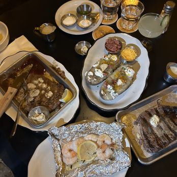 The Butterscotch Den - 2 Ribeyes, Prawns, Baked Potato, Cucumber Gimlet - Steakhouses Near Me - Sacramento, California The Butterscotch Den - 2 Ribeyes, Prawns, Baked Potato, Cucumber Gimlet - Steakhouses Near Me - Sacramento, California