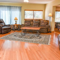 La Junta Guest Lodge - Deck House(4BR/2BA) This living room with wood floors, a great area to gather with family and friends.