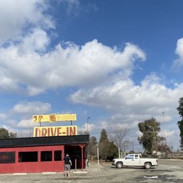a car parked in front of a drive - in a car parked in front of a drive - in