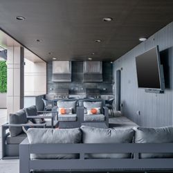 66 Summer Street - Covered outdoor lounge with gray seating and grill area