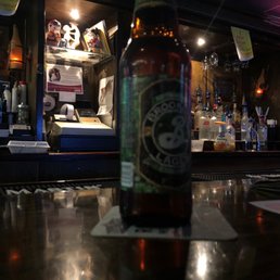a bottle of beer sitting on a bar