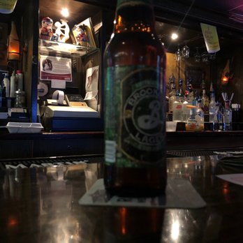 Henry Wok - a bottle of beer sitting on a bar - Chinese Near Me - Jersey City, New Jersey