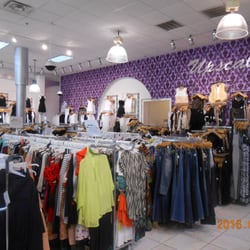 Upscale For Less - Display clothing inside store.
