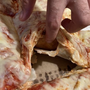 Leonardo's Pizza - Paper stuck to pizza - Pizza Near Me - Norwalk, Connecticut