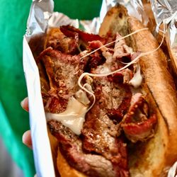 Truck’N Delicious - Smoked Tri-tip sandwich on garlic bread roll with provolone cheese.