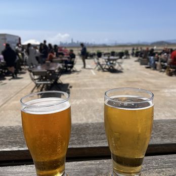 Faction Brewing - Outside sitting area! Super WINDY! L-R: Spring Time and Lager - Breweries Near Me - Alameda, California