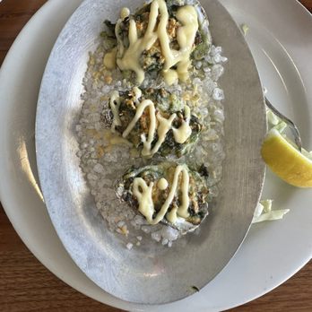 Firefish Grill - Rockefeller oysters: Pesto, parmesan cheese, spinach, and a mayo sauce. All on top of a cooked oyster. - New American Near Me - Santa Cruz, California Firefish Grill - Rockefeller oysters: Pesto, parmesan cheese, spinach, and a mayo sauce. All on top of a cooked oyster. - New American Near Me - Santa Cruz, California