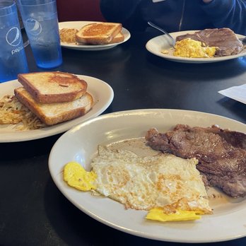 Norma's Carriage House - Rib-eye combo w/ eggs fried hard, sourdough toast, & hash browns. In back, t-bone combo w/scrambled eggs, sourdough toast, & hash browns. - Breakfast & Brunch Near Me - Springfield, Missouri
