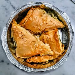 Lourdas Greek Taverna - Spanakopites: spinach and feta cheese wrapped in flaky phyllo dough.