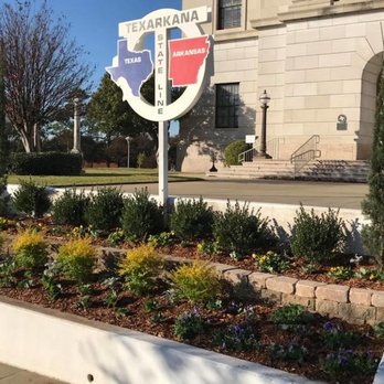 Young's Outdoor Solutions - a flower bed in front of a building - Landscaping Near Me Young's Outdoor Solutions - a flower bed in front of a building - Landscaping Near Me
