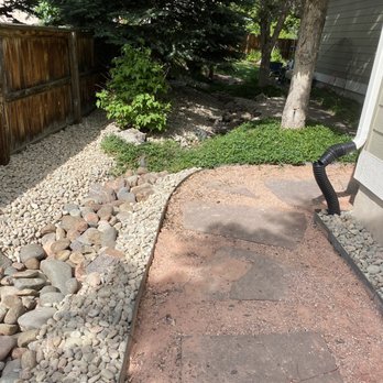 Superior Grounds Lawn Care - a stone path leading to a house - Landscaping Near Me